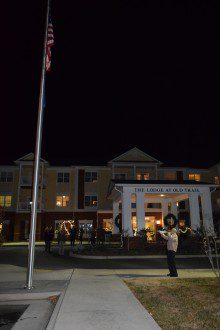 David-Christmas-Party-141-1-220x330 a man is standing in front of a building at night